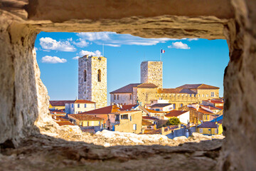 Historic French riviera old town of Antibes seafront and rooftops view through stone window