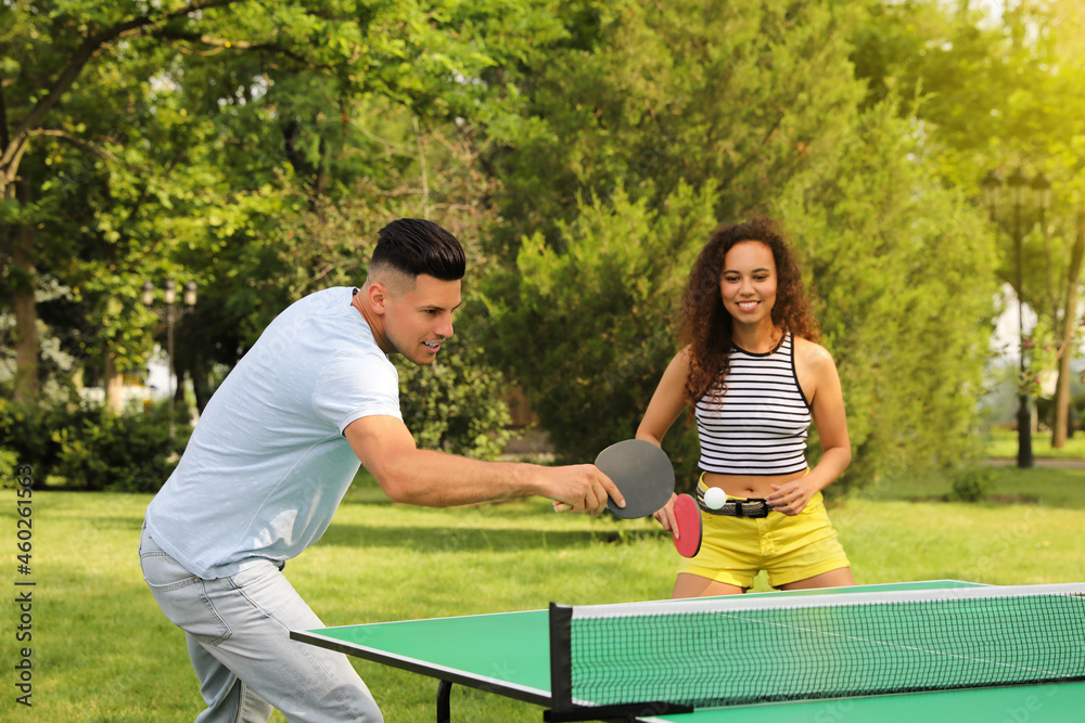 Wall mural friends playing ping pong outdoors on summer day