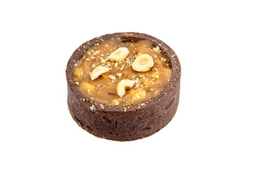 Mini caramel tart with hazelnuts isolated on white