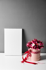 Blank canvas mockup with dried flowers on gray wall