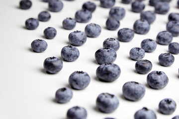 Blueberries with shadows on white table