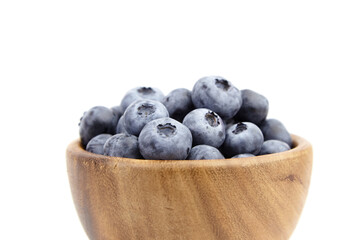 Blueberry in wooden bowl isolated on white background