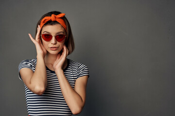 woman with orange bandage on her head wearing sunglasses posing fashion luxury