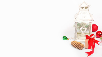 Christmas lantern with burning candle and festive ornaments on white background. New Year, winter concept. greeting card