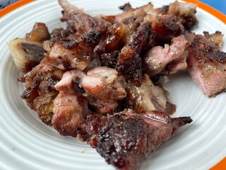 Roast pork and slices isolated in plate on white