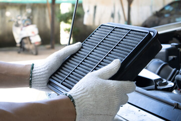 Manual car air filter replacement to maintain engine performance.Air filter is clogged. Causing...
