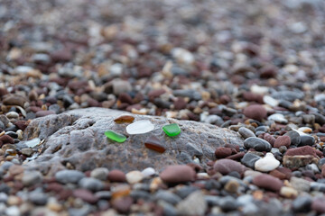 Sandy beach by the sea Arising from broken glass bottles Which was repeatedly hit by the waves...