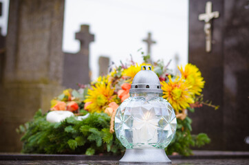 All Saints Day, funeral concept with candles, lantern and colorful floral decoration