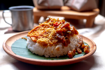 Nasi Campur, Indonesian Typical Food from East Java Province. Contain white rice, spicy tofu, tempeh, serundeng, and fried noodles