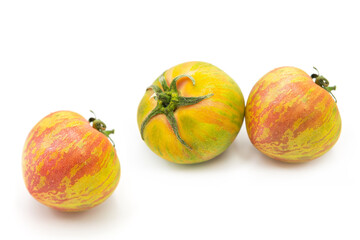 Fresh ripe organic striped zebra tomatoes whole isolated on white background.	