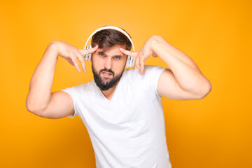 Fototapeta na wymiar bearded man in headphones emotionally performs dance movements to music.
