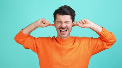 Exhausted troubled guy fingers close ears loud neighbor noise concept