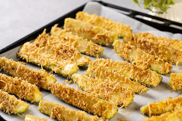 raw sliced zucchini, breaded in breadcrumbs and cheese, ready to bake in the oven, semi-finished product