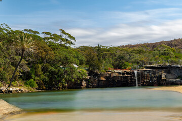 Fototapeta na wymiar Panoramic views of Wattamolla Beach with waterfall tress turquoise blue waters and nice white sandy beach in sydney NSW Australia