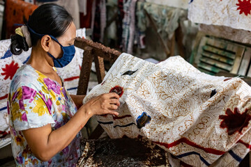 A batik craftsman is making batik. Batik is one of Indonesia's cultural heritage which has become an icon of UMKM and national clothing that has gone global.