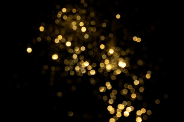 Golden blurred bokeh lights on black background. Glitter sparkle stars for celebrate. Overlay for your design