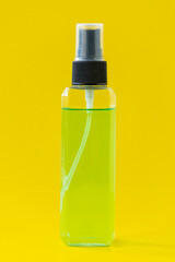 Square perfume bottle isolated on yellow background..