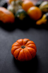 Autumn Pumpkin Thanksgiving Background - orange pumpkins over black table