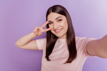 Portrait of pretty positive nice attractive lady take selfie show v-sign cover eye on purple background