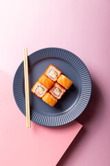Traditional Japanese food Philadelphia sushi on a modern pink background, minimalistic concept