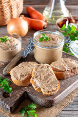 Fresh homemade chicken liver pate on bread on rustic background - obrazy, fototapety, plakaty