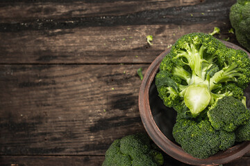Green fresh broccoli on old wooden background. Ripe vegetables for diet and healthy eating