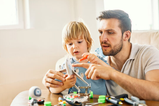 father child son family man boy together parent craft hobby tool workshop work handmade learning teaching creative toy