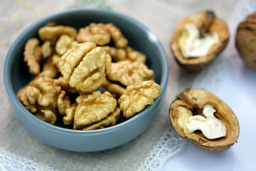 Young grains of walnut top view. Walnuts peeled and in shell on a tablecloth on the table. Large brown nuts, whole. 