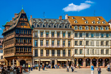 Nice view of a row of buildings on the Place de la Cathédrale in Strasbourg including the famous Kammerzell House, one of the most ornate and well preserved medieval house in late Gothic architecture. - obrazy, fototapety, plakaty