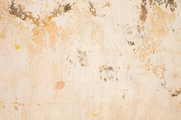 The old cement wall, painted and putty, peels off and collapses. Grunge background texture