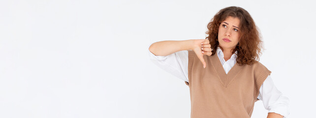 Dislike sign. Wrong choice. Portrait of disappointed skeptic woman disapproving with thumb down gesture isolated on white empty space background. No signal. Failure mistake.