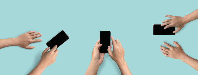 Top view of hands touching screen on mobile phone isolated on solid color background. of free space for your copy, view from top.