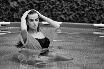 Portrait of a beautiful woman in the swimming pool.