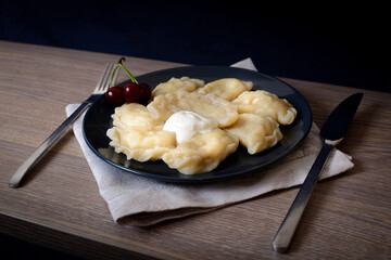 Dumplings with meat cherries vegetables cabbage pork turkey beef. A traditional Russian dish. Delicious and healthy breakfast.