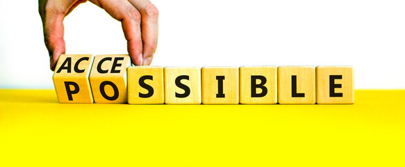 Possible and accessible symbol. Businessman turns wooden cubes and changes the word possible to accessible. Business and possible or accessible concept. Beautiful white background, copy space. - obrazy, fototapety, plakaty