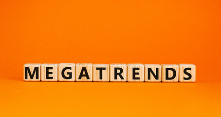 Megatrends symbol. The word megatrends on wooden cubes. Beautiful orange table, orange background. Business and megatrends concept. Copy space.