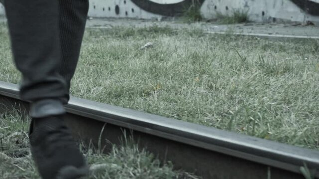 the guy is balancing on the tram tracks