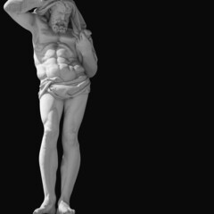 Naklejka premium Hephaestus. In Greek and Roman mythology god of the forge and blacksmiths. An ancient statue on black background. Copy space.