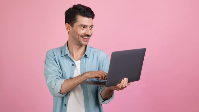 Cheerful funny programmer remote worker typing netbook code