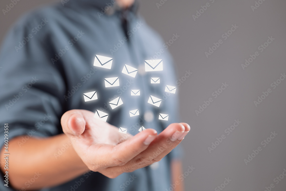Aufkleber hand of a businessman with an e-mail icon contact us through email to receive our newsletter and sec