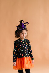 Happy girl dressed as a witch for Halloween