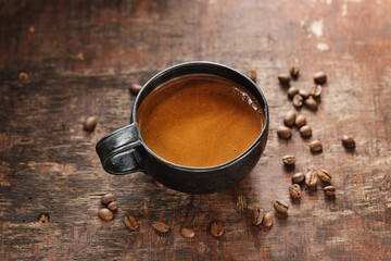 Coffee espresso in cup with coffee beans