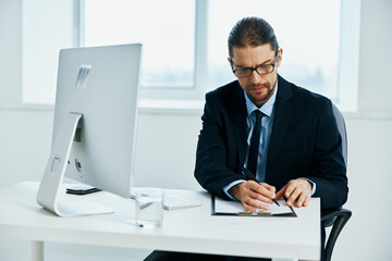 businessman sitting at a desk in front of a computer technologies