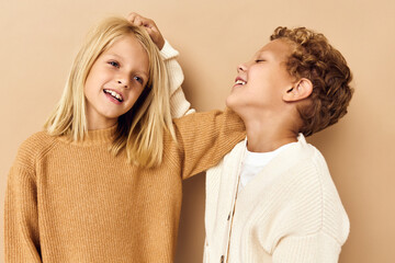 boy and girl smiling and posing in casual clothes isolated background