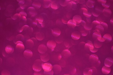 Abstract glittering pink glitter bokeh on blurry background.