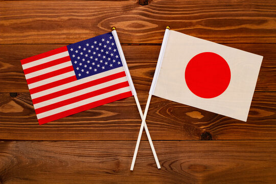 Flag of USA and flag of Japan crossed with each other. USA vs Japan. The image illustrates the relationship between countries. Photography for video news on TV and articles on the Internet and media