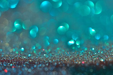 Abstract turquoise bokeh glitter on nature background