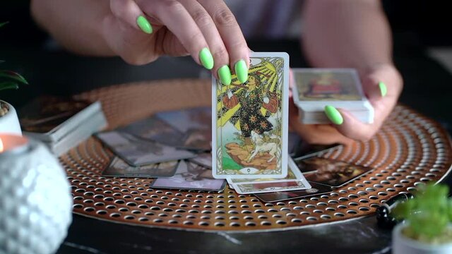 Fortune teller woman showing the card. Slow motion
