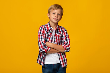 Confident calm european teenage boy in casual with crossed arms looking at camera