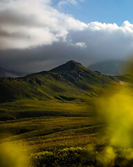 Beautiful photography of the mountain Oshten. Dramatic sky in the background and sun rays. Idea of tourism and hiking, breathtaking nature. High mountain in Russia.